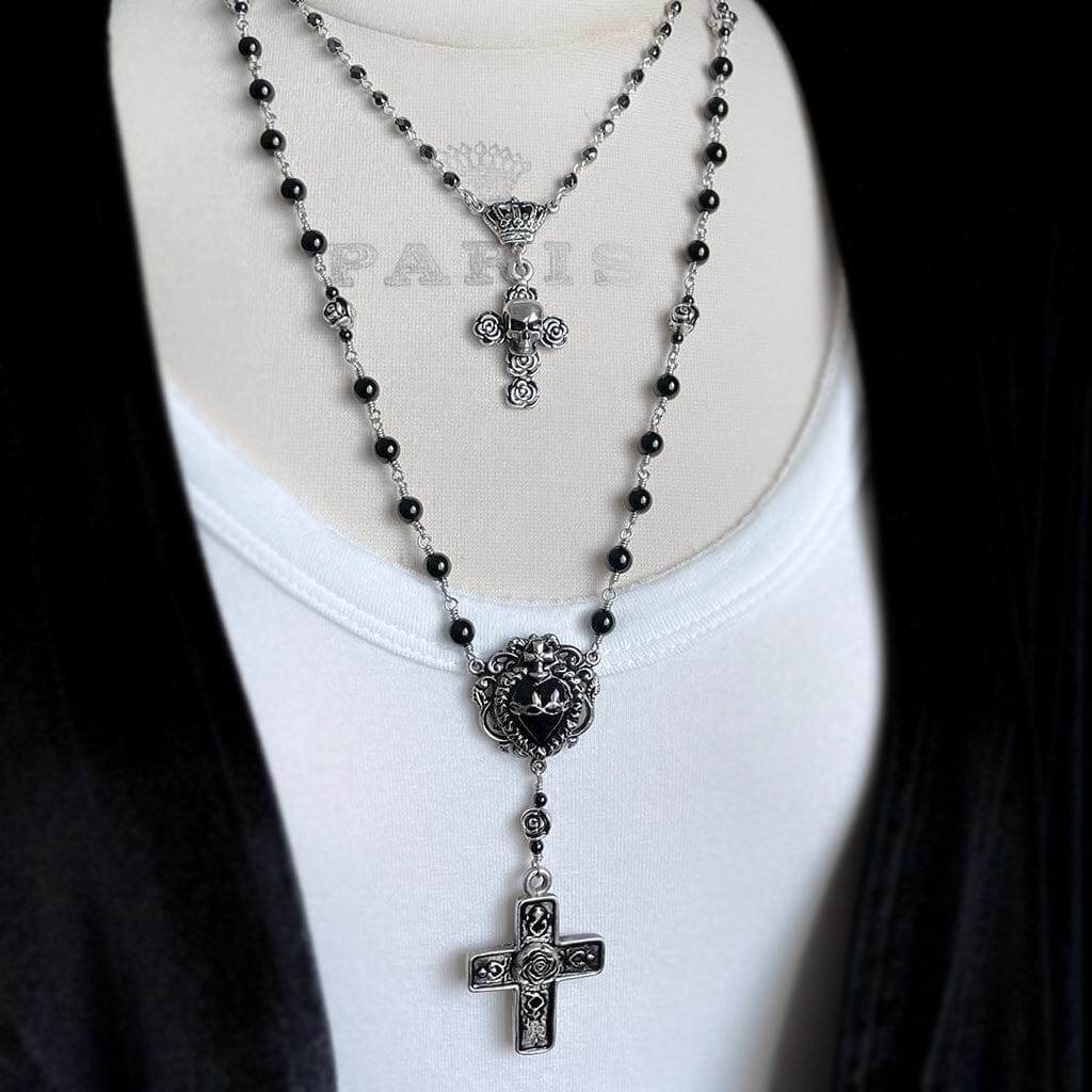 image showing the skull and rose rosary necklace styled with a longer rosary necklace