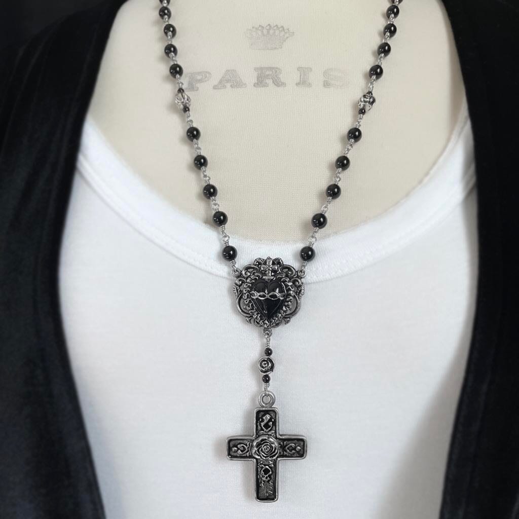 styled photo showing the black sacred heart rosary necklace by rock my wings