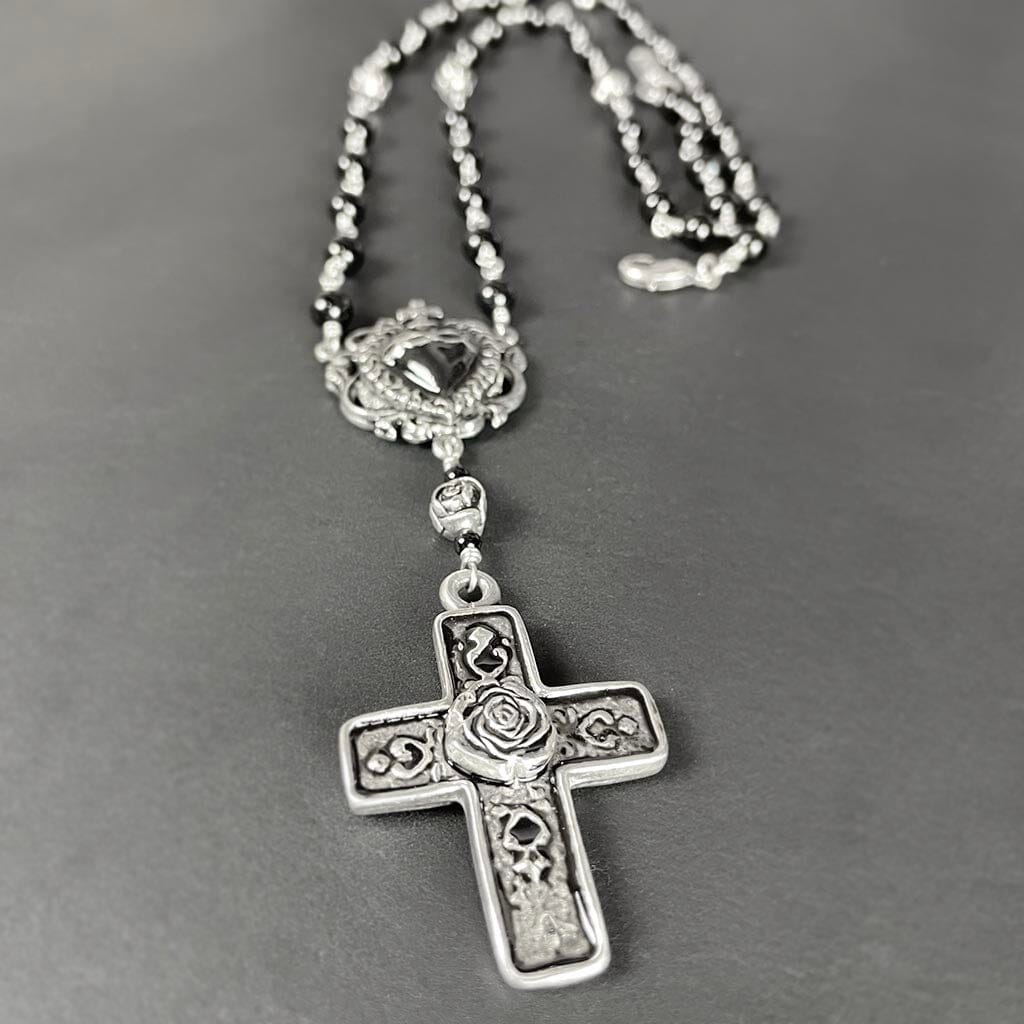 close up showing the detail in the cross of the rosary necklace